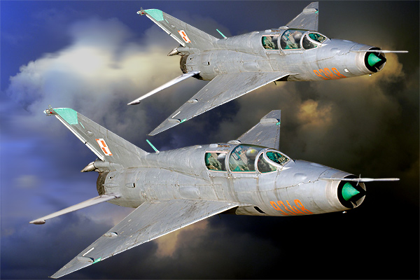 DIGITAL ART! 2 MiG- 21 UM`s of the Polish Airforce  seen here flying tohgeter.  Its the same aircraft but I copied and change the 9348 with a fictive registration. The 9348 is staing at Nadarzyce and the aircraft is parket near the Controle tower. Photoshop 7,0 the them fly again  Nikkor 17/35 AF/s 1/2,8G Lens  1/350-sec F-7,1 100-Iso focal lenght 55-mm.